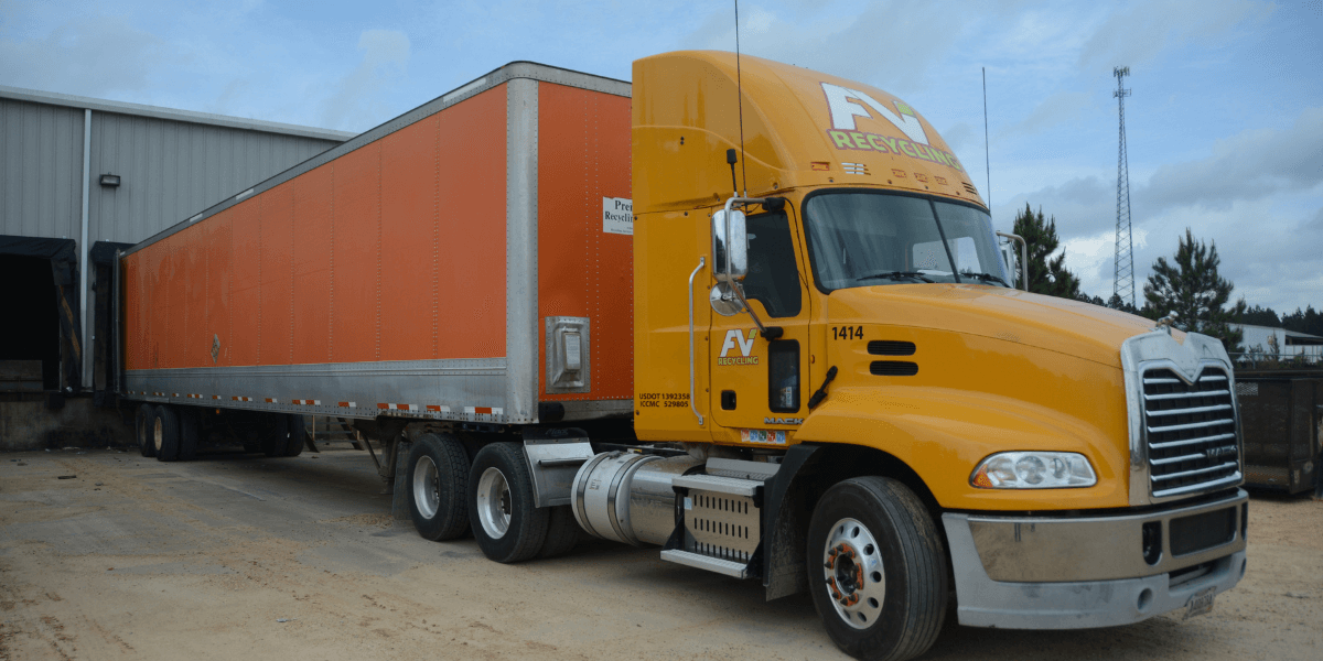 FV Recycling truck is transporting commercial cardboard recycling loads from an industrial facility to reduce landfill waste and improve waste management efficiency.