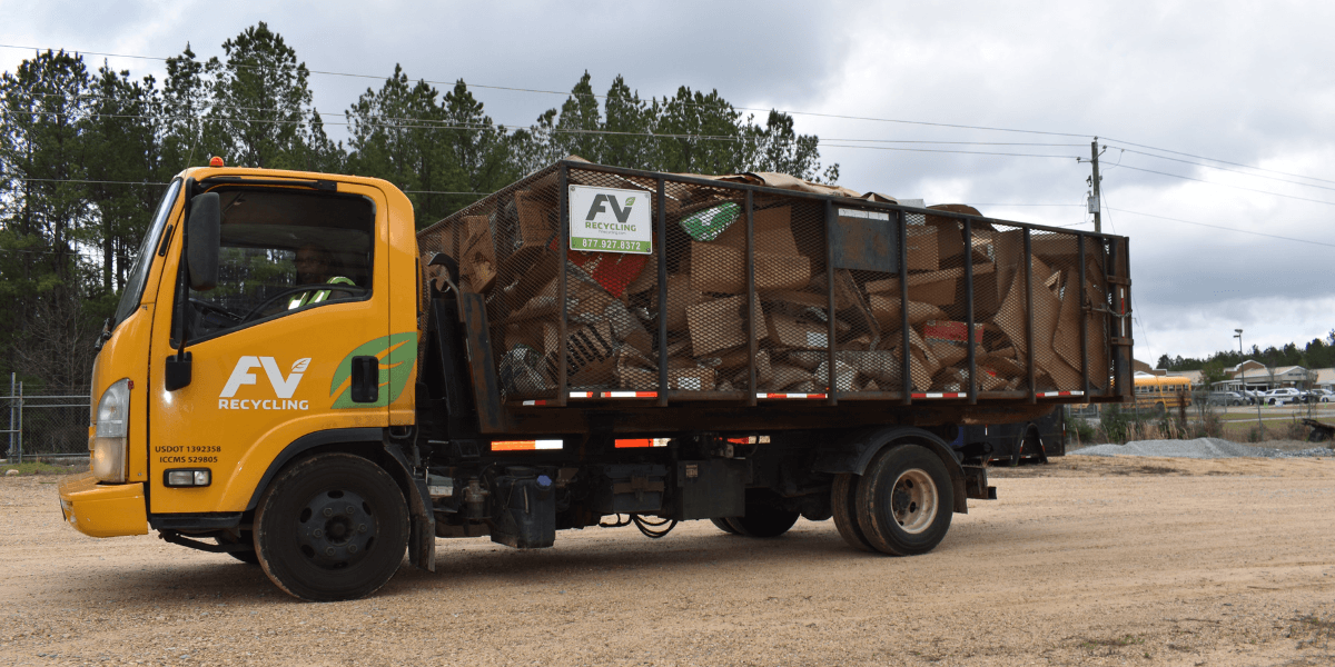FV Recycling bale route hauling truck transporting a container of cardboard collected from a commercial customer.