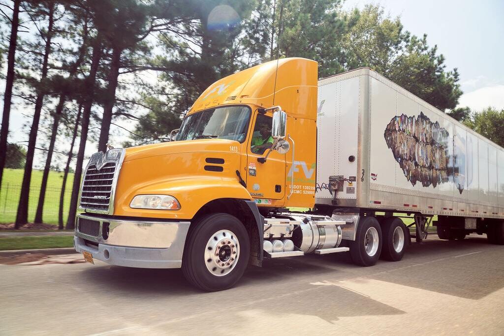 Yellow FV Recycling 18-wheeler attached to a large white trailer