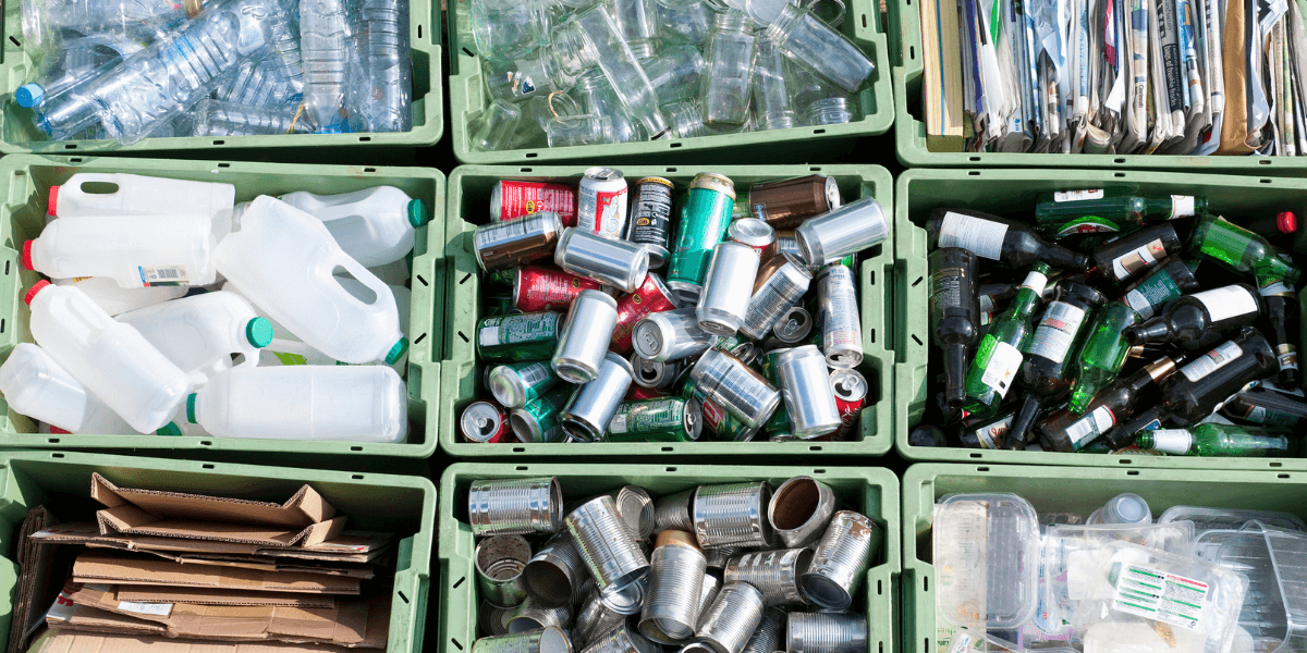 separated plastic, aluminum, glass and paper recyclables in green bins