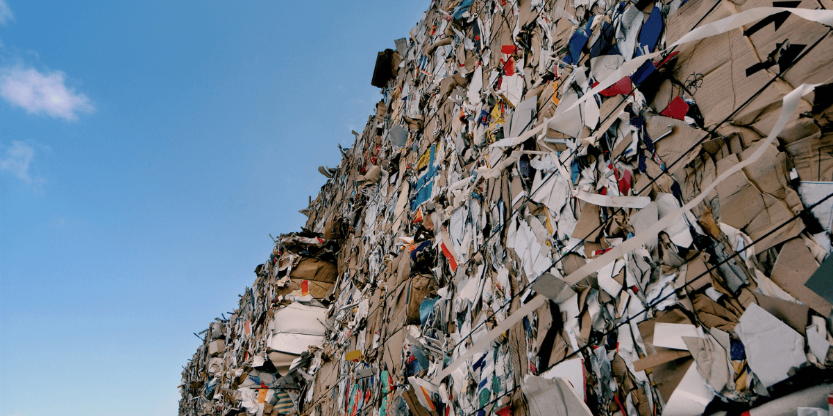 stacks of paper in bales piled up outside